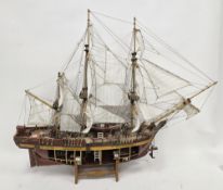 Wooden kit-built model of HMS Bounty, one side of the hull open revealing the inner decks with