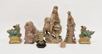 Group of carved Asian soapstone figures of deities; a Bodhisattva riding a lion dog; a pair of