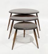 Ercol dark stained elm and beech nest of three pebble tables on turned legs, largest 41cm high x