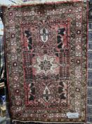 Eastern salmon ground rug with three central geometric medallions, multiple floral borders, 159cm