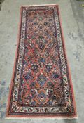 Eastern salmon ground rug with floral field, multiple geometric and floral borders, 223cm x 83cm