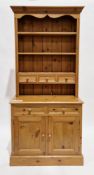 Modern pine dresser, the upper section with three fixed shelves and three small drawers, the lower