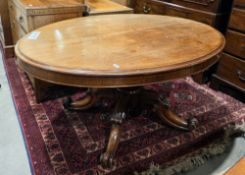 Victorian mahogany centre/loo table of oval form, the tilt-top on a octagonal faceted baluster