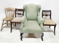 20th century wingback armchair, 109cm high, a pair of Regency-style mahogany dining chairs with