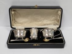 Cased silver three-piece cruet set, Birmingham 1936, A J Bailey, the salt and mustard pot of plain