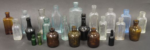 A collection of early 20th century small apothecary bottles in blue, clear and brown tints,