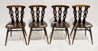 Set of four Ercol dark elm and beechwood dining chairs, model 375, with triple fleur-de-lys splat