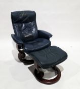 Stressless reclining armchair on circular supports upholstered in blue leather, with footstool