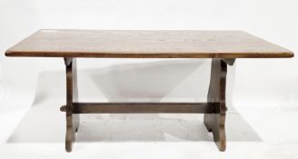 Mid-century oak dining table, the rectangular top on a trestle style base united by a cross