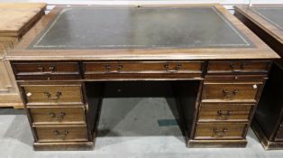 Mahogany twin pedestal desk in the George lll manner, the rectangular top with green leather and