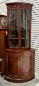 19th century mahogany and ebony inlaid bowfronted corner cabinet, the upper section with moulded