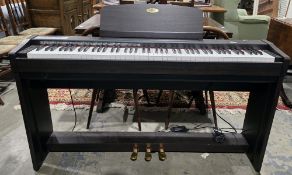 A Kawai digital piano model CL30, with a rosewood finish, 95cm high x 138cm wide x 28cm deep