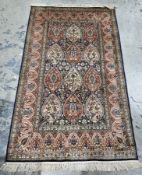 Persian-style silk midnight blue ground rug with three rows of three floral and stylised bird