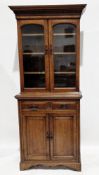 Late 19th century oak library bookcase with dentil moulded cornice over two arched glazed doors