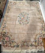 Large pink ground superwash carpet with central floral motif and floral border 390cm X 270cm