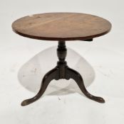 George III oak table, the circular tilt-top on a turned baluster column with three outswept