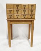 Mid-century Libraco of London pale oak filing cabinet comprising a bank of 12 small filing