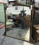 A 19th century overmantel mirror, the ebonised and gilt shaped wooden frame with raised gilt wood