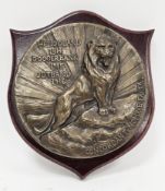 World War I circular bronze badge plaque relating to HMS Lion, decorated in relief with a lion and