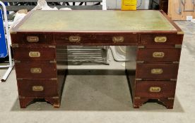 Mahogany twin-pedestal desk in the 19th century campaign manner, the rectangular top with green