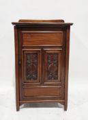 Early 20th century mahogany cupboard, the single door with foliate carved panels, opening to three