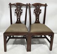 Set of four mahogany dining chairs in the George III Chippendale manner, with pierced carved splats,