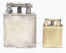 Two 1920's Alfred Dunhill lift-arm table lighters, one in a silver plated case and the other in a