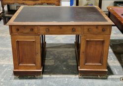 Victorian twin-pedestal desk, the rectangular top with inset writing surface and thumb-mould edge,