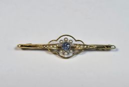 Edwardian 15ct yellow gold brooch, collet set with a central old cut round sapphire and surrounded