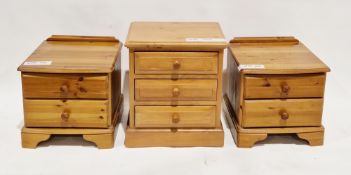 Pair of pine bowfronted bedside cabinets, each with two drawers with knob handles, on bracket