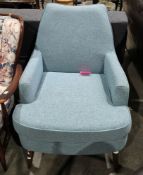 Modern easy chair in the mid-century style, retailed by Made, having a blue/green fabric upholstery,