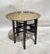 Benares-style brass top table, the circular tray top with engraved decoration including birds and