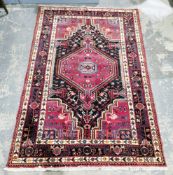 Possibly Turkish brown ground rug with large central hooked geometric medallion on geometric