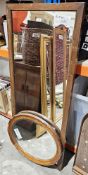 Two wall mirrors, the first of stained oak oval form with beaded frame, the other of rectangular