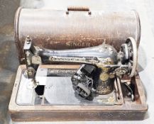 Singer portable sewing machine in oak carrying case (please note VAT will be payable on the