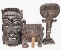 Collection of African and ethnic wooden carvings including African tribal figure carrying an