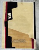 Modern wool pile cream ground rug with red and black geometric pattern, 215cm x 154cm