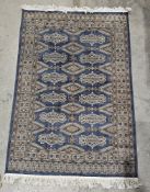 Large blue ground rug with one row of five octagonal medallions flanked by two rows of six geometric