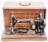 Late 19th century Singer Manufacturing Company model 12 sewing machine with gilded decoration,