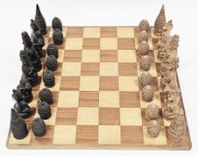 Sri Lankan/Burmese faux stone chess set in the form of Buddhist figures, animals and stupas, tallest