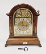 Early 20th century oak bracket clock, the domed top with a brass dial having Roman and Arabic