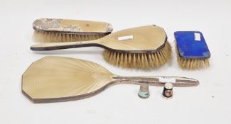 Enamel and silver-backed three-piece dressing table set comprising mirror and two brushes, another