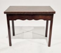 19th century mahogany folding card table, the rectangular top with flowerhead carved edges, shaped