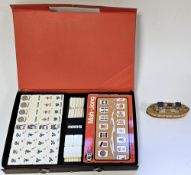 Boxed Mahjong set together with a small wooden boat
