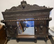 Victorian dark oak hall mirror comprising a central mirror surrounded by a heavily carved frame