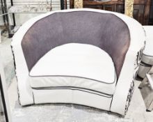 Contemporary white leather and fabric snuggle armchair of curved form, having black fabric seat with