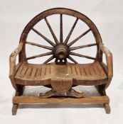 Rustic handcrafted hardwood bench, the back formed from an iron bound 14-spoke cartwheel, with