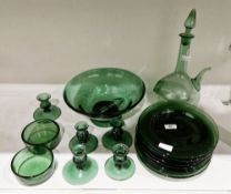 Group of green tinted glassware including a footed bowl, a decanter and two stoppers, five