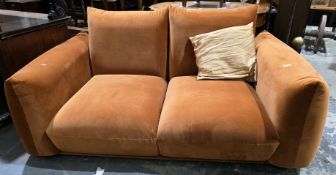 Gianni two-seater sofa upholstered in a rust velvet fabric, 68cm high x 170cm wide x 97cm deep