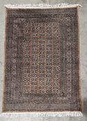 Large green ground rug with central lozenge trelliswork, multiple geometric borders flanked by